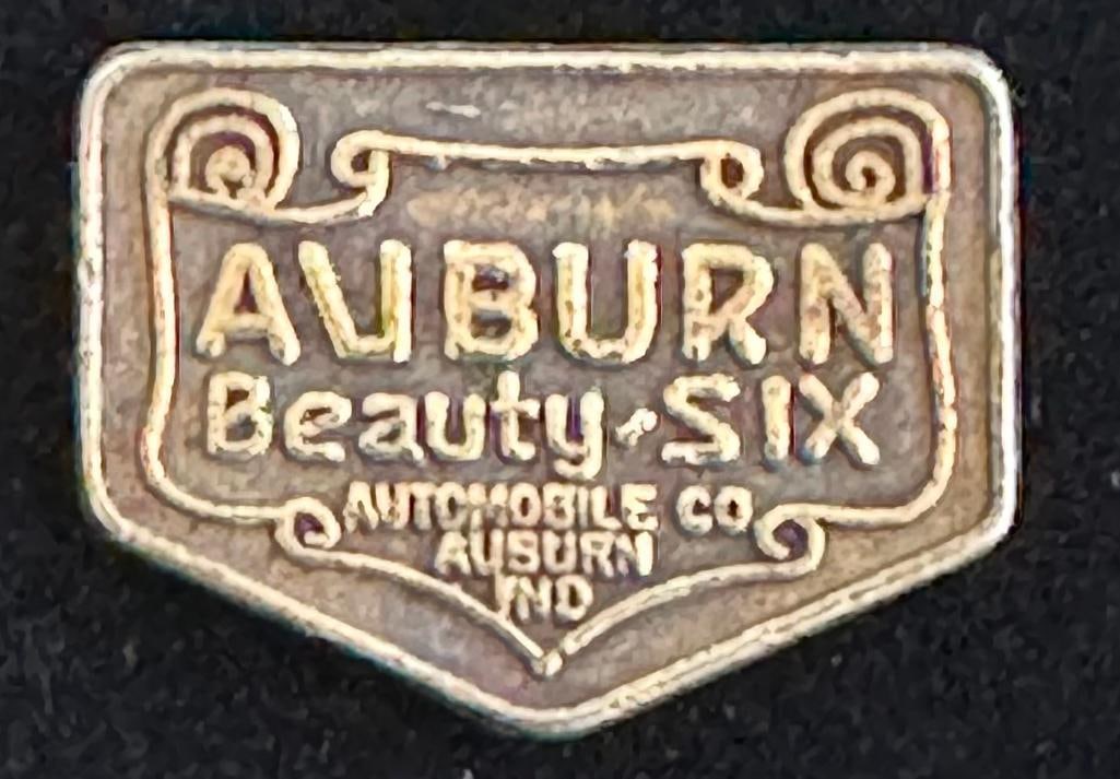 1919 - 1924 Auburn Beauty Six Emblem: 1919 - 1924 Auburn Beauty Six Emblem. The emblem measures approximately 1" wide by .5" high.