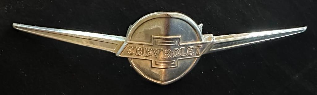 1934 - 1936 Chevrolet Emblem: 1934 - 1936 Chevrolet Emblem. This emblem measures approximately 8.5" wide by 1.75" high. It has a Northern Eng. & Mfg. maker's mark.