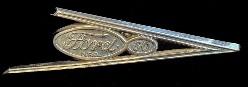 Ford Grille Emblem: 1937 Ford grille emblem. This emblem measures approximately 6.25" wide by 2.25" high.