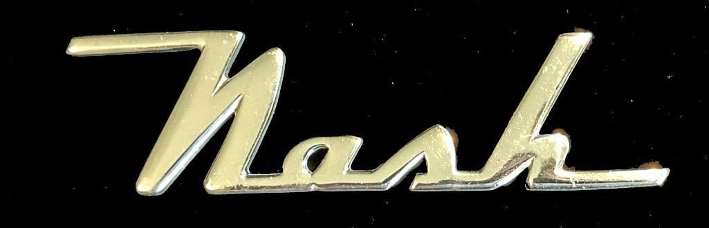 Nash Fender Script Emblem: 1940 Nash fender script. This emblem measures approximately 4" wide by 1" high.