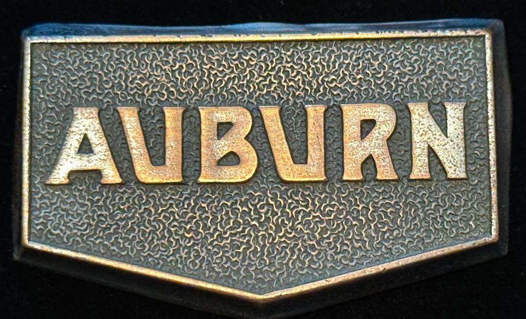 Auburn Radiator Emblem: 1931 - 1932 Auburn radiator emblem. This emblem has a Fox maker's mark and measures approximately 2.5" wide by 1.5" high.