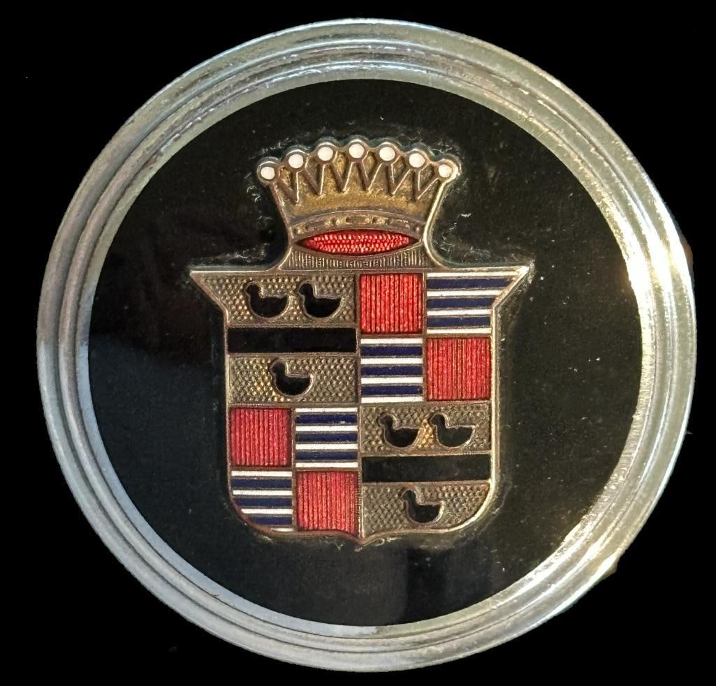 Cadillac Radiator Emblem: 1930 V8 Cadillac radiator emblem. The emblem has a DL Auld maker's mark and measures approximately 2.2' in diameter.