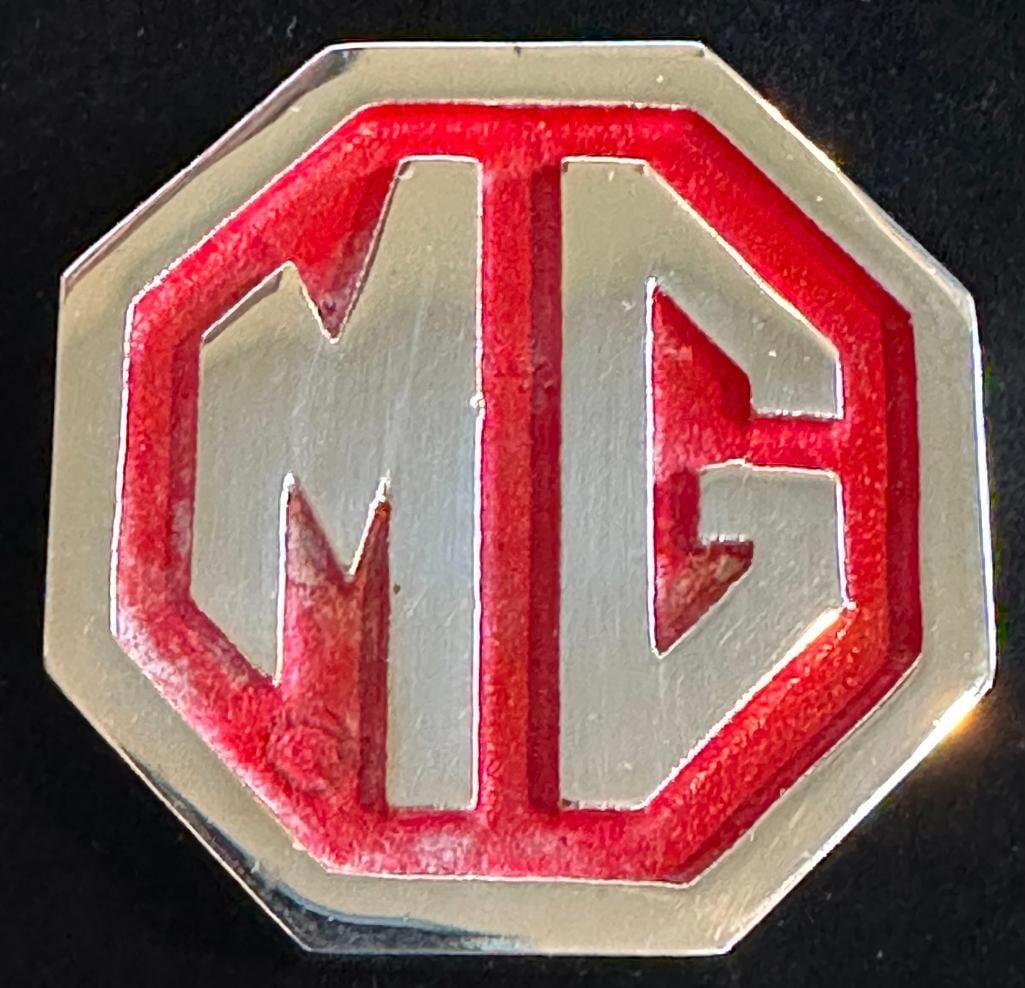 MG Paperweight: MG paperweight. This item measures 2.2" wide by 2.2".
