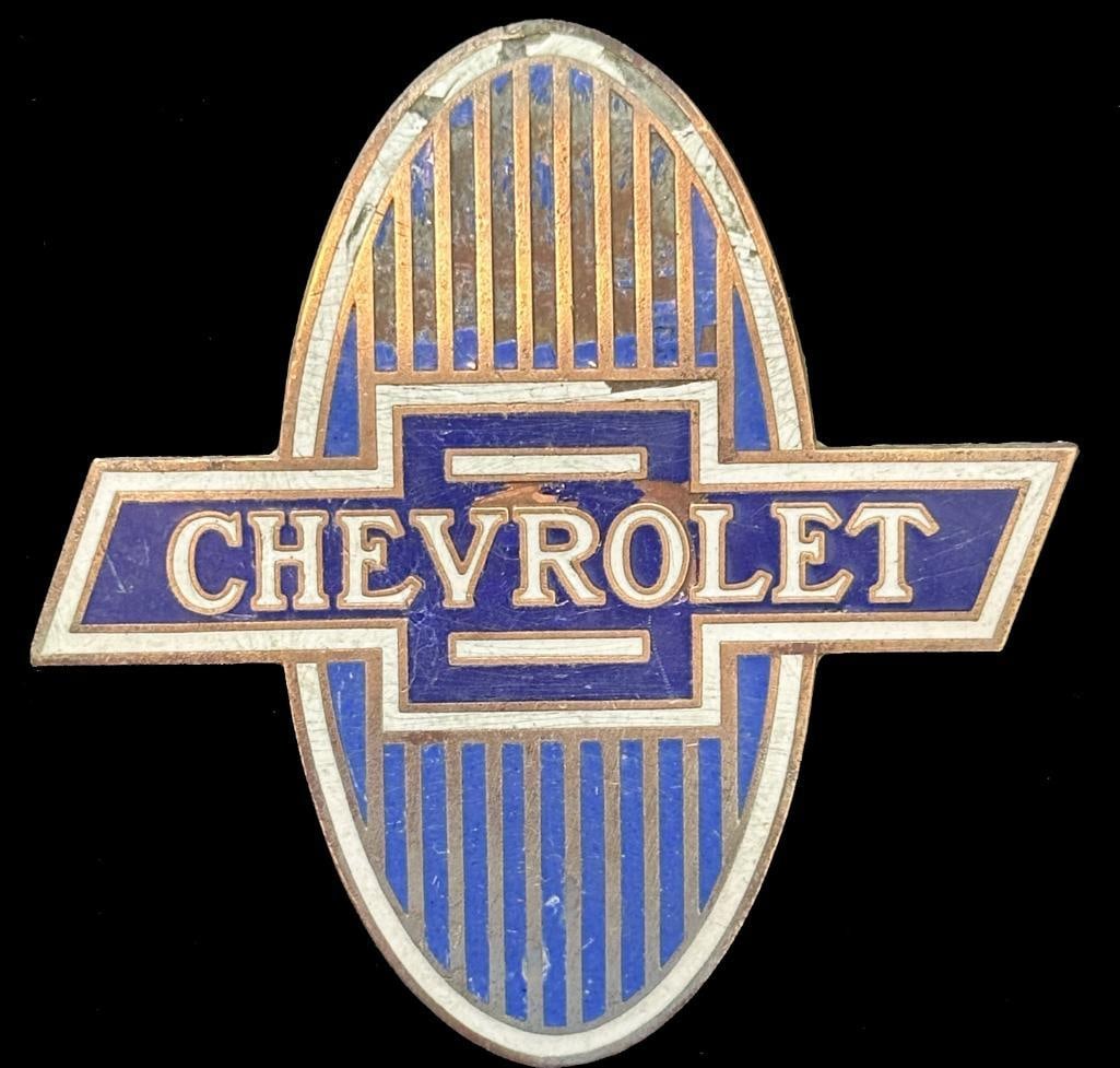 Chevrolet Radiator Emblem: 1929 - 1932 Chevrolet radiator emblem. This emblem has a DL Auld maker's mark and measures approximately 3" high by 3" wide.