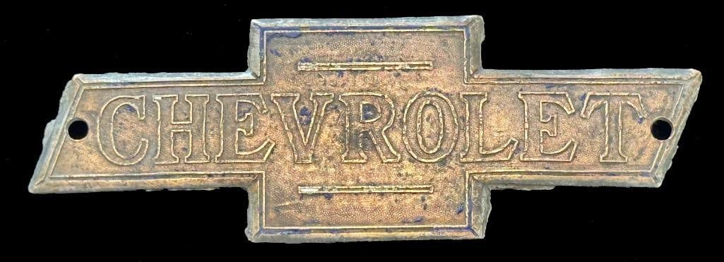 Chevrolet Radiator Emblem: 1913 - 1915 Chevrolet radiator emblem. This is the 1st Chevrolet radiator emblem. This emblem has a Shepard maker's mark and measures approximately 4.25" wide by 1.5" high. The holes are not original.