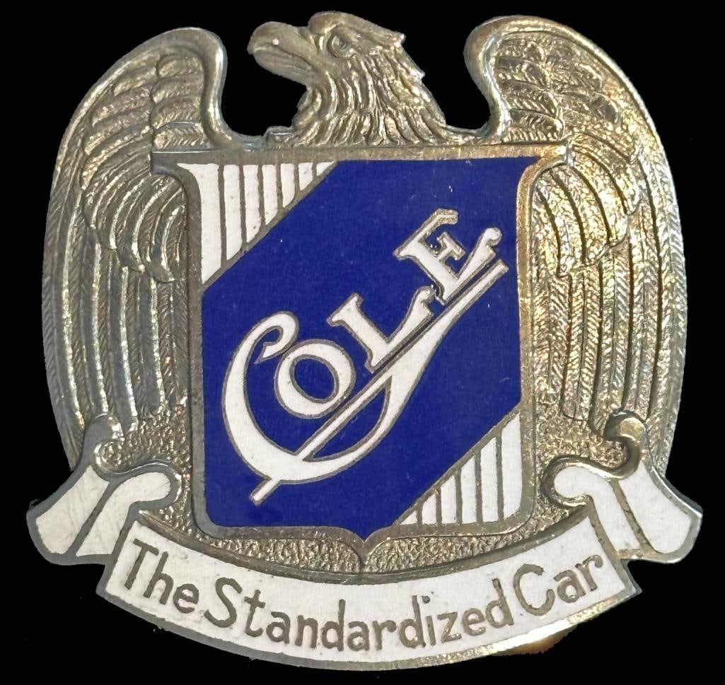 Cole Radiator Emblem: 1913 Cole radiator emblem. This emblem looks to be New Old Stock (NOS). It is rated rare and measures approximately 2.2" wide by 2" high.