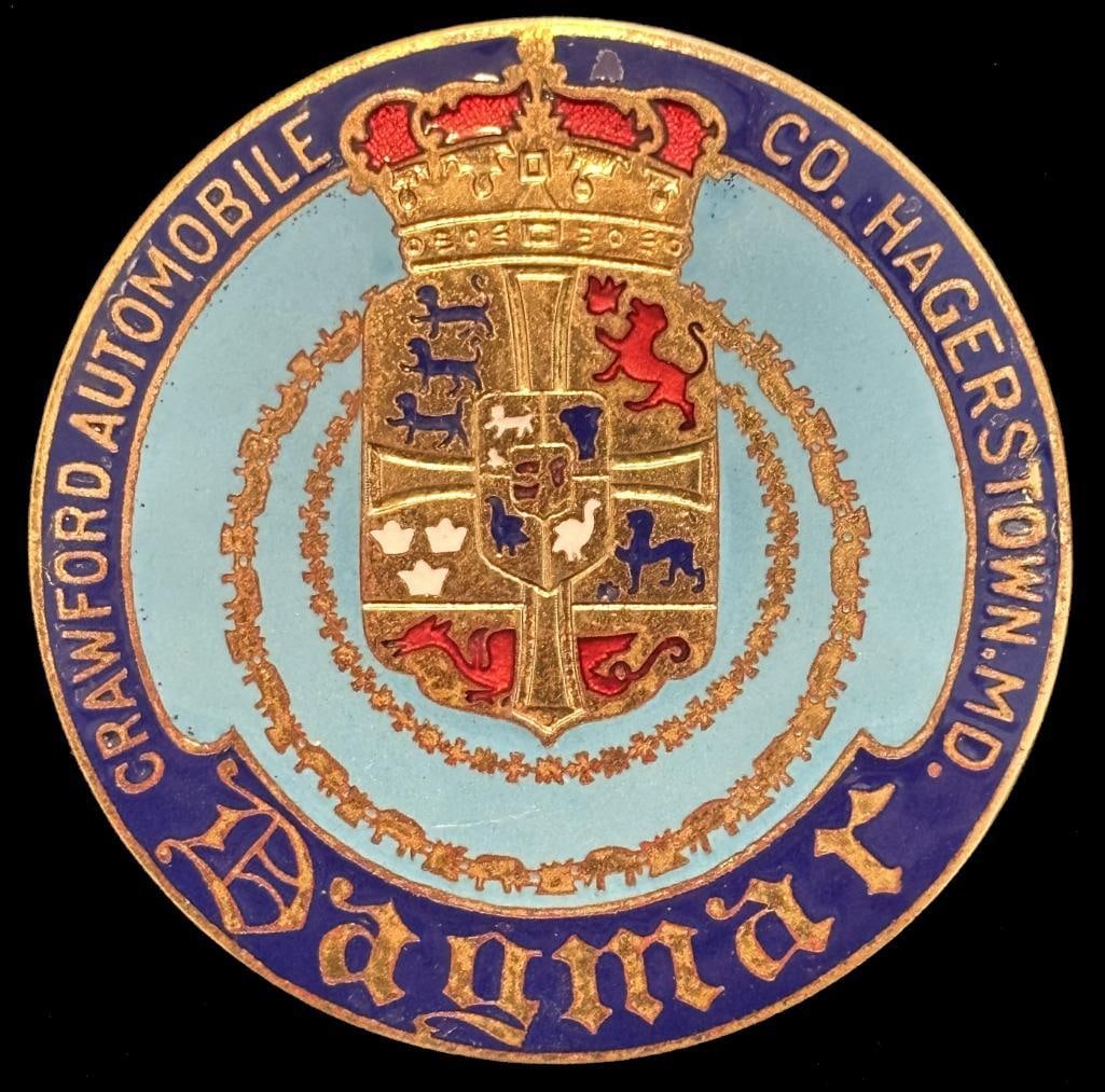 Dagmar Radiator Emblem: 1924 Dagmar radiator emblem. This emblem looks to be New Old Stock (NOS) and has a Whitehead & Hoag maker's mark. It is rated scarce and measures approximately 2.5" in diameter.