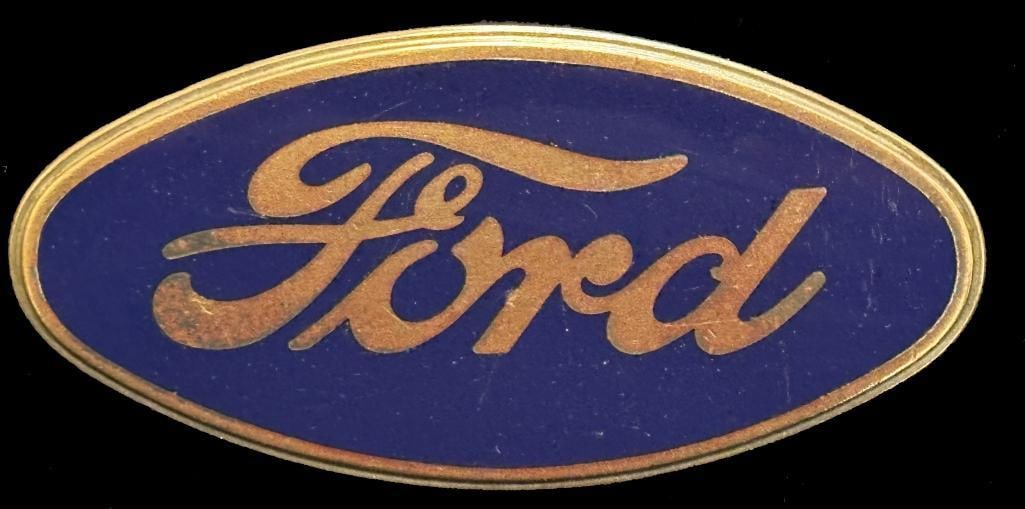 Ford Radiator Emblem: 1927 - 1929 Ford radiator emblem. This emblem has a DL Auld maker's mark and measures approximately 2.9" wide by 1.4" high.