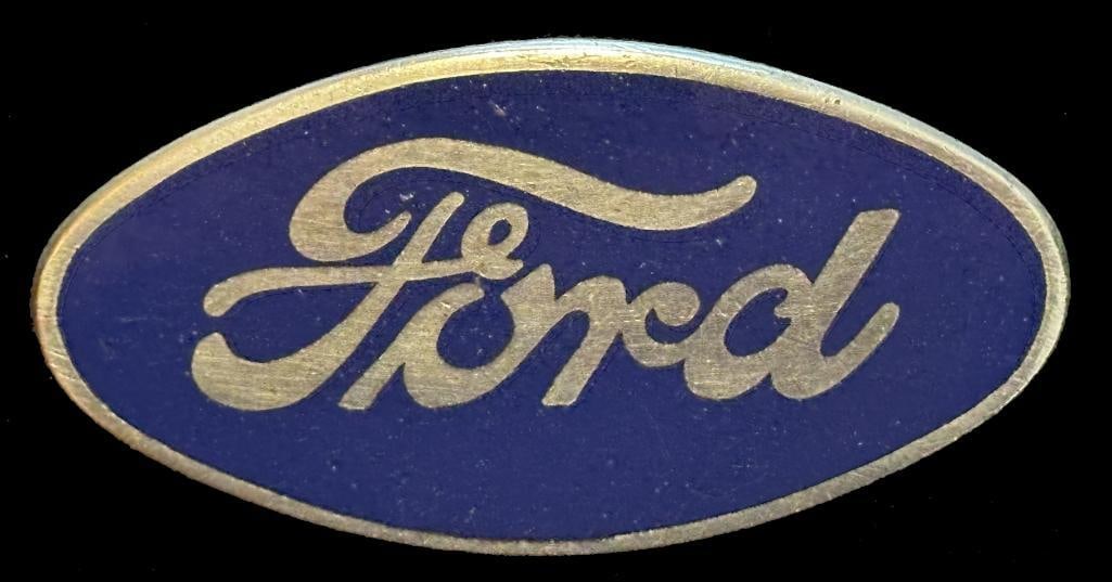 Ford Radiator Emblem: 1929 - 1930 Ford radiator emblem. This emblem has a Robbins maker's mark and measures approximately 2.9" wide by 1.4" high.