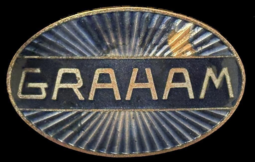 Graham Radiator Emblem: 1934 Graham radiator emblem. This emblem measures approximately 2.6" wide by 1.6" high.