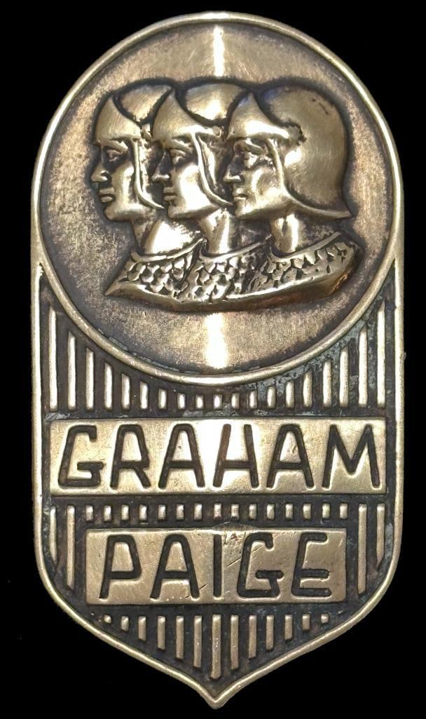 Graham-Paige Radiator Emblem: 1928 Graham-Paige radiator emblem. This emblem has a Fox maker's mark and measures approximately 2.5" high by 1.5" wide.