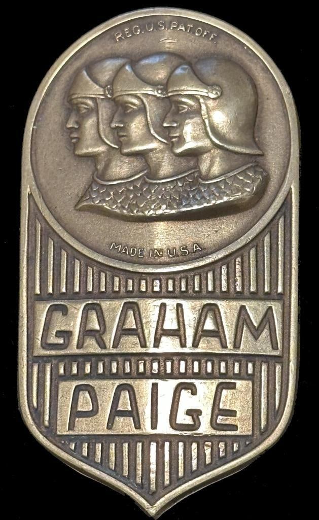 Graham-Paige Radiator Emblem: 1928 Graham-Paige radiator emblem - "Make In U.S.A." version. This emblem has a DL Auld maker's mark and measures approximately 2.5" high by 1.5" wide.