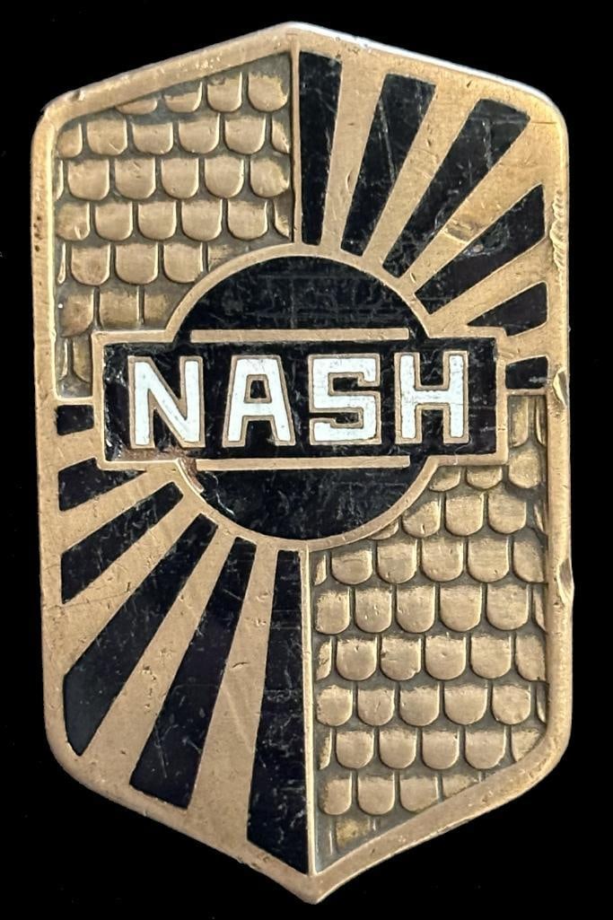 Nash Radiator Emblem: 1928 - 1931 Nash radiator emblem. This emblem has a Robbins maker's mark and measures approximately 2.5" high by 1.5" wide.