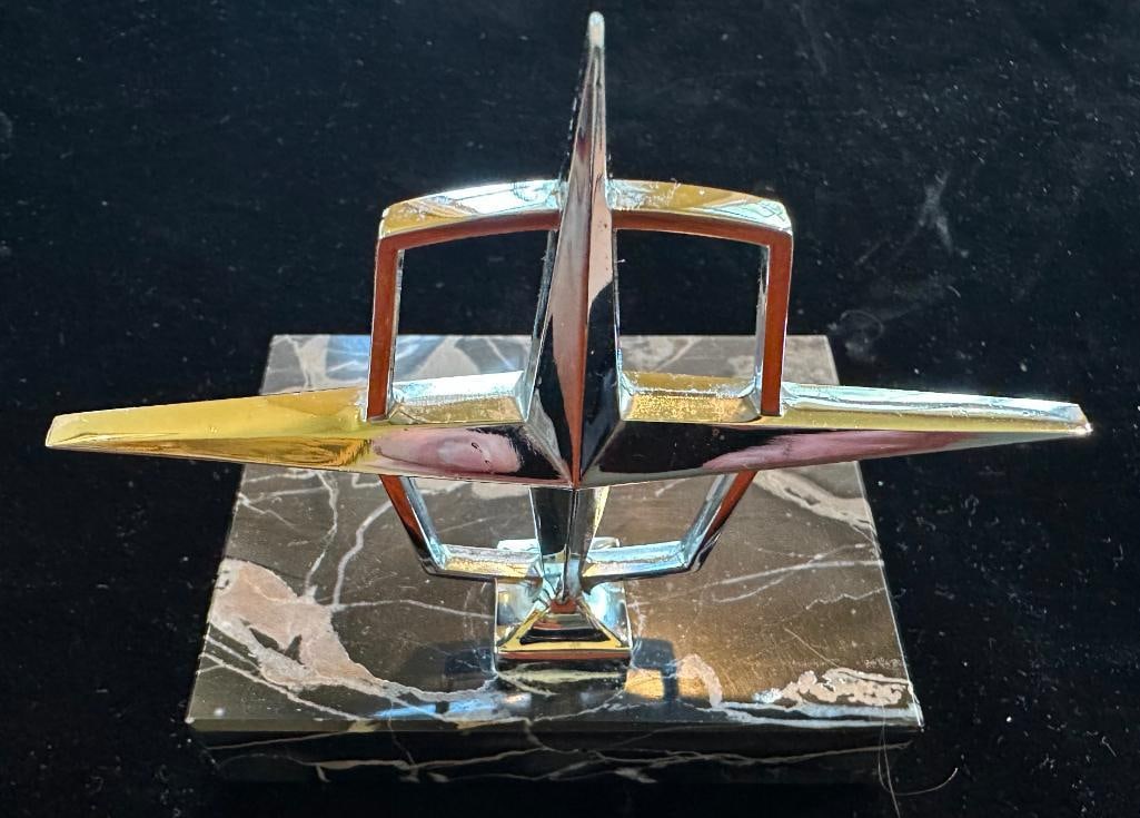 Lincoln Continental Hood Ornament: 1961 - 1964 Lincoln Continental Hood Ornament. Mounted to marble base. This item measures approximately 4.5" wide by 3.4" high.
