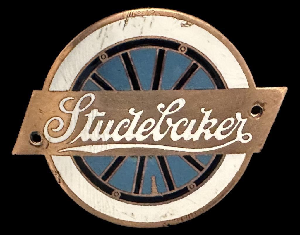 Studebaker Radiator Emblem: 1924 - 1926 Studebaker radiator emblem. This emblem measures approximately 2.5" wide by 2" high. The holes are not original.