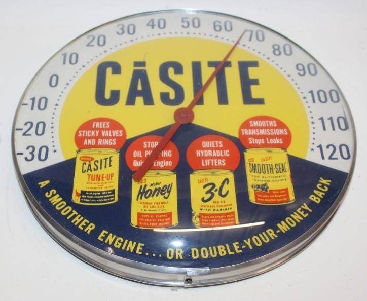 Casite "A Smoother Engine?" Advertising Thermometer: This thermometer has a glass face and correctly tells temperature. The face has good bright colors with just a few surface scratches. This thermometer measures 12" x 12" and is graded an 8.75.