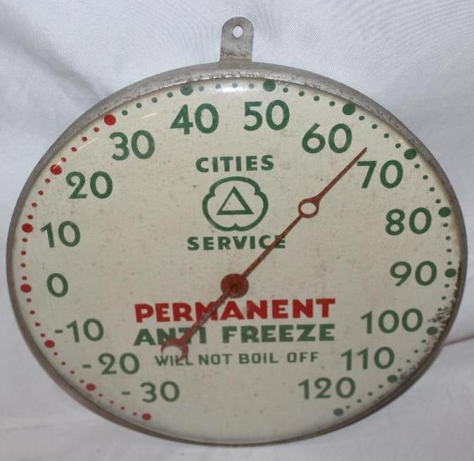 Cities Service Permanent Anti Freeze Advertising Thermometer: This thermometer is in working condition and has a glass outer face. There is some slight paint flaking to the perimeter of the dial. This thermometer measures 12" x 12" and is graded an 8.
