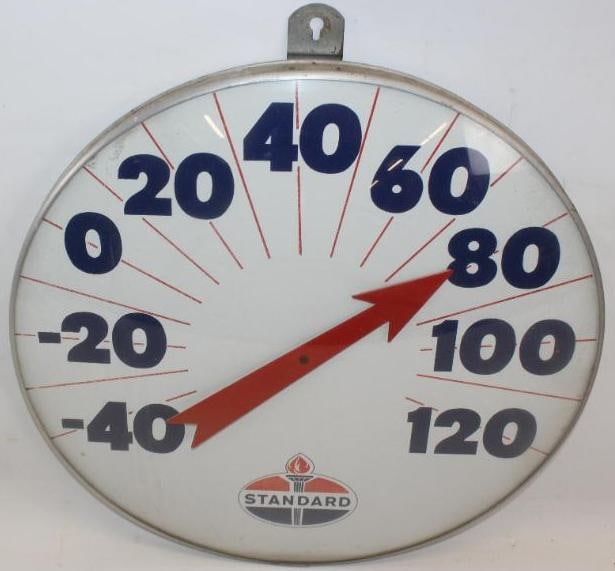 Large Standard Oil Company Advertising Thermometer: This thermometer has the original glass lens and painted face. The therm is working and keeps temperature. There is some light surface wear and staining to the dial. It measures 18" x 18" x 3" and is