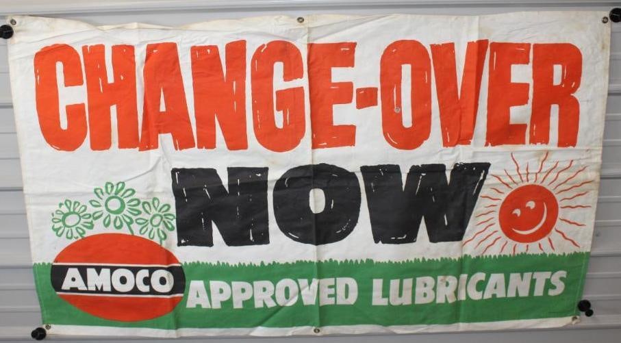 Amoco Approved Lubricants Change Over Now Advertising Canvas Banner: This banner is marked the Igelstroem-Oberlin inc. There is a small tear in the middle. There is also some slight staining and wear with folds that may improve. This banner measures 34.5" x 60" and is