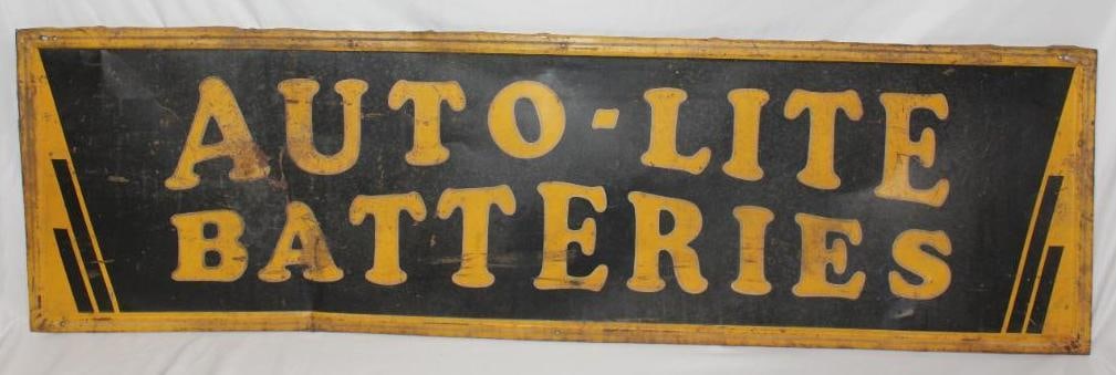 Auto-Lite Batteries Horizontal SST Sign: This sign has rust staining and wear throughout as well as a bend on the left side. There are also a few holes added along the self framed edge. This sign measures 59" x 17" and is graded a 6.5.