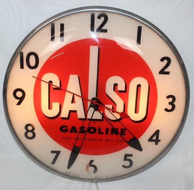California Oil Company Calso Advertising PAM Light Up Clock: This clock is in very good overall condition. It lights up and works as intended. It does show some areas of slight paint loss in a few of the numbers. This clock measures 15" x 15" x 5" and is graded