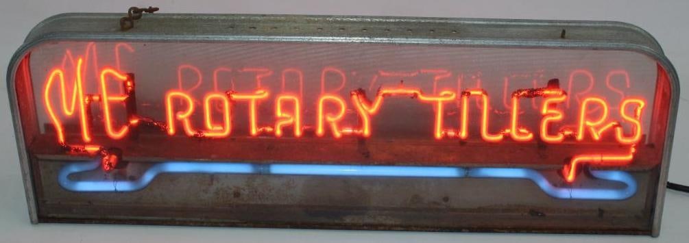 Milwaukee Equipment Rotary Tillers Neon Advertising Display Sign: This neon sign lights up and works. It is in its original frame and housing. The letter panel along the bottom edge is missing. The can and frame both show oxidation. The sign measures 30.5" x 10" x 8
