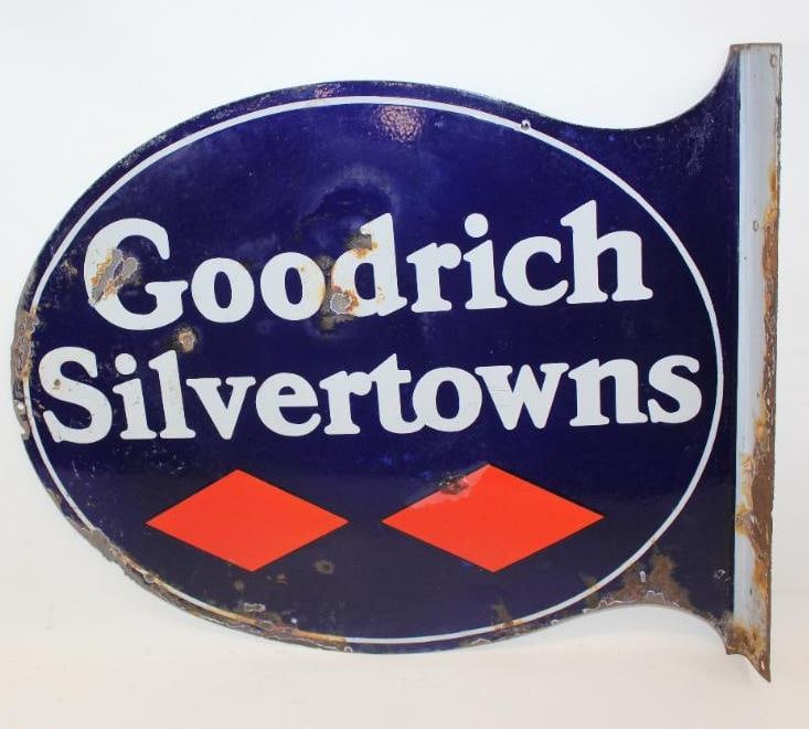 Goodrich Silvertowns DSP Porcelain Flange Sign: The display side of this sign shows several chips throughout the field. There is also some rust along the perimeter and flange. The reverse side has some chips and fading to the blue areas of the fiel