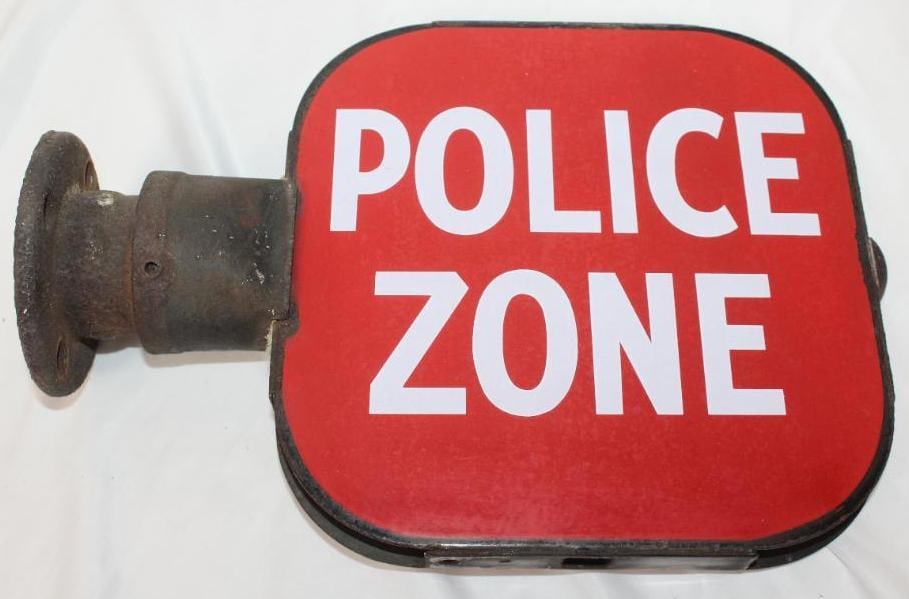 Porcelain Police Zone DSP Sign with Mounting Bracket: This sign has some slight discoloration. The field is very clean on both sides. The overall measurement is 14" x 10" x 1" and is graded an 8.75.