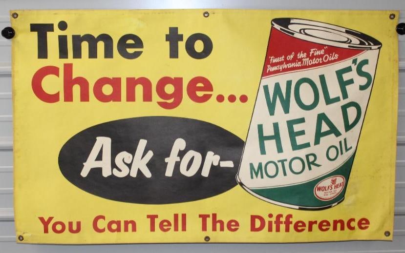 "Ask For" Wolf's Head Motor Oil Advertising Banner: This is a heavy paperstock banner with great oil can graphics. It does show some slight staining, and light creases along the perimeter. There is also some rust staining by the original grommets. This