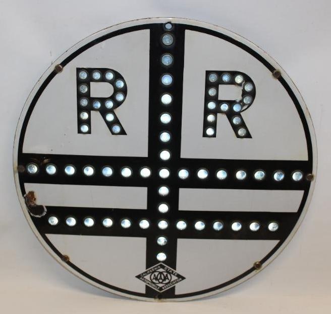 California AAA White Porcelain Railroad Sign with Glass Cat Eye Reflectors: This sign has great color and gloss throughout with two small chips to the right R, and near the left edge. The width of the cat eye reflectors is 0.75". The overall measurements of this sign are 24"