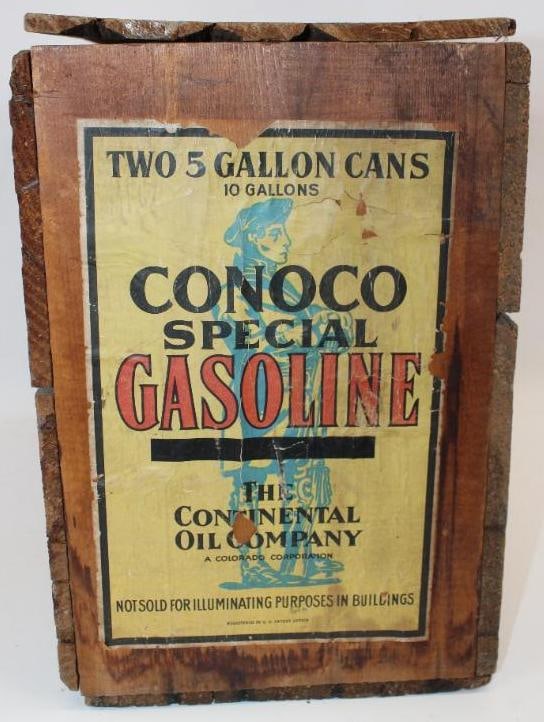 Conoco Minuteman Five Gallon Oil Can Wooden Crate: This crate would hold two five gallon oil cans. It has a paper label attached to one end, and a gasoline label attached to the other. The paper label shows some age wear and cracks throughout. The cra