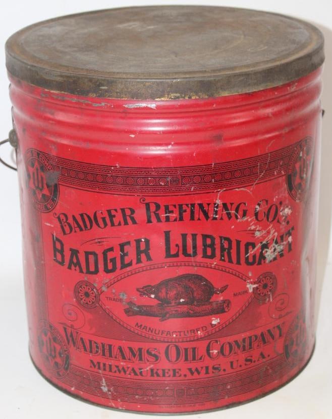 Wadham's Oil Company Badger Grease Can: This is a large size grease can with great early graphics. There are some surface scratches and wear to the field. The can measures 13.5" x 12" x 12" and is graded a 7.75.