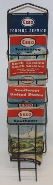 Esso Touring Service Advertising Map Rack Display: This display rack has a single sided metal sign at the top. The display also includes six original Esso maps. The sign does show some slight rust staining and wear. This display measures 20" x 4.5" x