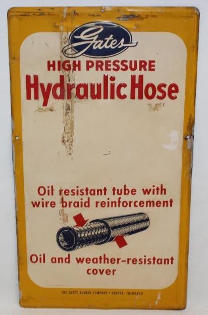 Gates High Pressure Hydraulic Hose Embossed SST Sign: This sign shows some staining to the field as well as areas of tape residue. There are also small areas of paint loss along the raised edge. It has a makers mark of AMD 11-57. This sign measures 30" x