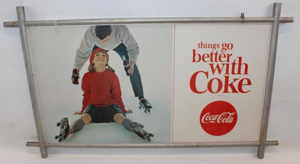 1964 "Things Go Better With Coke" Coca-Cola Advertising Sign with Roller Skating Graphics: This sign has a metal frame. It is in good condition with some slight surface wear throughout the field. The overall measurements are 40.25" x 24.5" and is graded an 8.25.