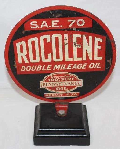 Rocolene Motor Oil DST Paddle Sign: This sign has some light wear and flaking throughout. This sign is mounted to a wood base. It measures 7" x 7.5" and is graded a 6.5.