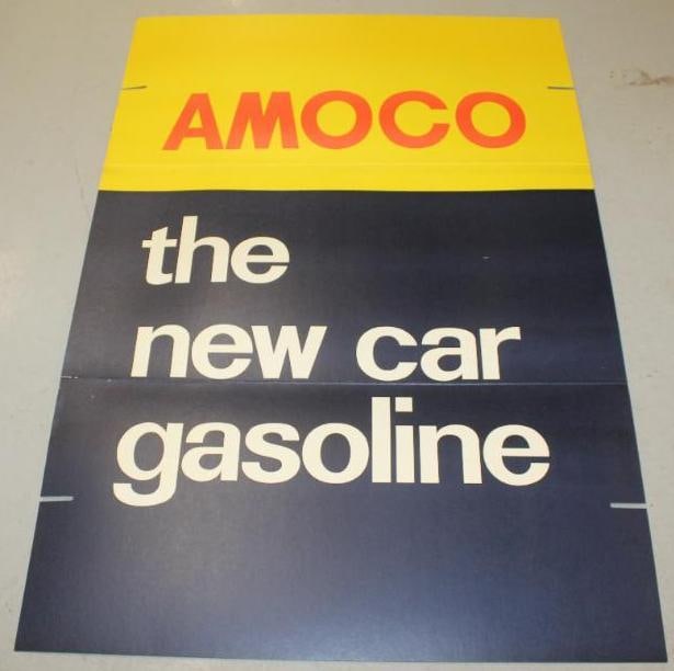 Group of 2 NOS 1971 Amoco Service Station "The New Car Gasoline" Post Signs: These are heavy cardboard signs in their original shipping box. These signs are in very nice overall condition with only minor wear. They both measure 70" x 45.5" each when folded and is graded an 8.5