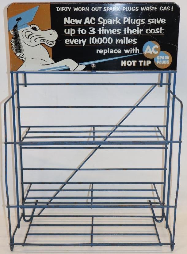 Graphic AC Spark Plugs Advertising Display Rack: It is in very nice condition with a clean field and light edge wear. It is graded and 8.75. The sign measures 14" x 5.5" and the overall measurments are 14.25" x 5.5" x 21.