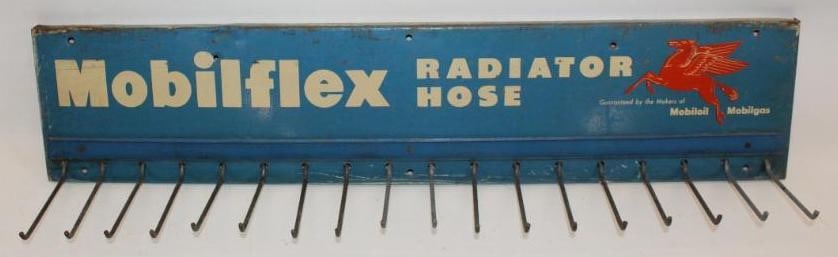 Mobilflex Radiator Hose SST Display Rack Sign: This sign shows some slight discoloration to the white lettering, as well as light surface scratches and wear to the field. This sign measures 31.5" x 7" and is graded an 8.