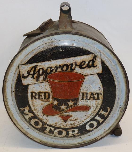 Independent Red Hat Five Gallon Rocker Oil Can: This is an iconic Approved Red Hat oil can with large graphics. The display side shows some rust staining throughout the field, as well as some fading in the white areas. The reverse has heavier rust 