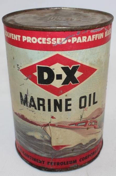 Graphic DX Marine Round Metal 1 Quart Oil Can: This is a very difficult to find DX Marine can with boating scene graphics on both sides. The display side shows discoloration and wear throughout while the reverse has slightly heavier wear and dents