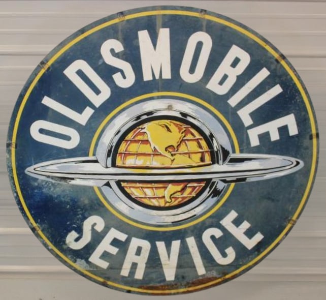 Oldsmobile Service Dealership Advertising DST Sign: This is a unique double sided painted metal dealership sign with the world graphics. You would most often find the porcelain version of this sign. The display side shows good color, but scratches and 