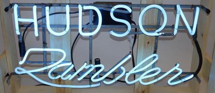 Hudson Rambler Dealership Neon Sign: This is a working neon sign that would have hung in the winow of a Hudson Rambler dealership. It is currently mounted in a new wooden crate. The crate measures 37" x 25" x 13". The neon sign measures 