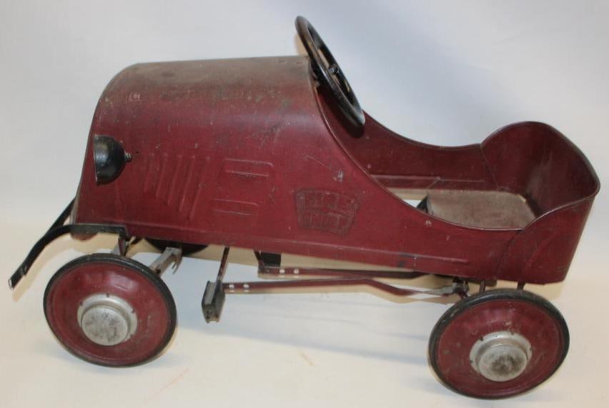 1930s Boycraft Fire Chief Pedal Car: This great early pedal car retains its original paint, and front liscense plate. You can also see remnants of the fire chief logos. It does have some general wear and use throughout, but remains strai