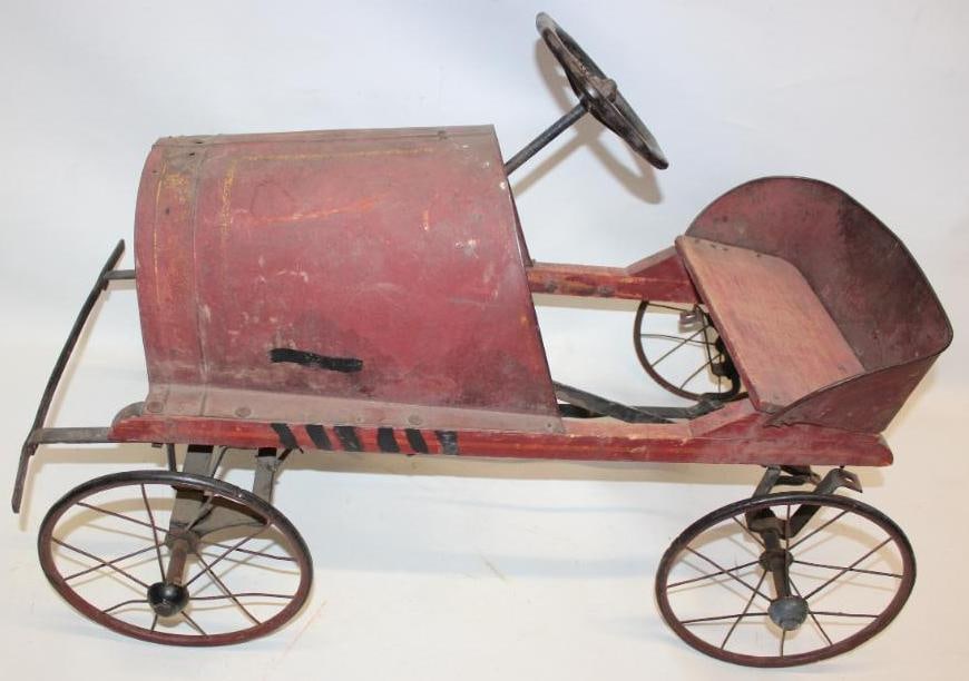1920s American National Pedal Car Marked Jewett Car Co: This pedal car retains its original paint showing general use and wear throughout. It displays very well overall. The metal panels remain straight and solid. The wooden radiator retains its original J