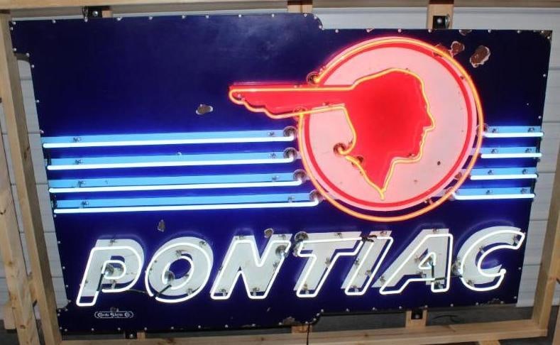 Impressive Pontiac Dealership Porcelain Neon Advertising Sign: This porcelain dealership neon sign presents very nicely. It does have some chips throughout the field as well as light surface wear and scratches. It is mounted on a newer metal can with hanging brac
