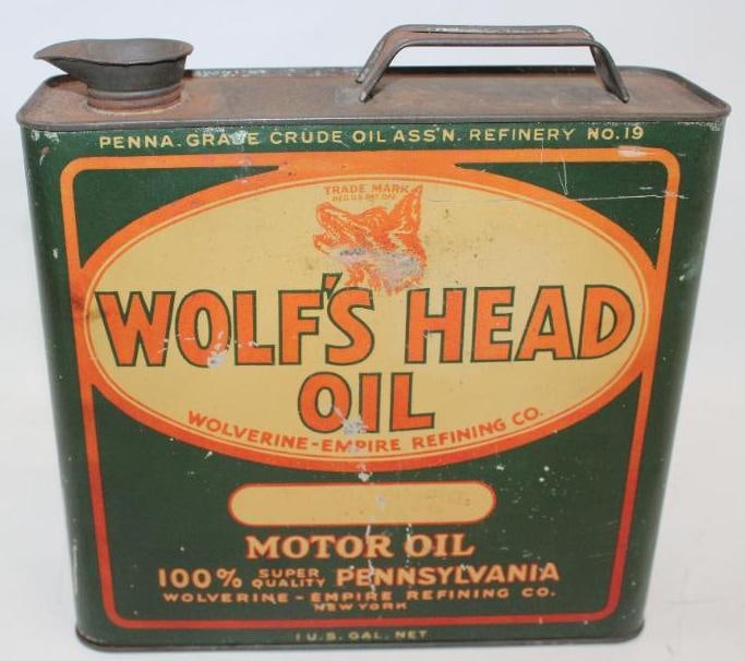 Wolf's Head 1 Gallon Motor Oil Can: This is the early style Wolf's Head with detailed wolf graphics. Both sides show some light scratches and wear throughout the field. It is graded 8 and 7.75. The measurements are 9.5" x 9.5" x 3.25".