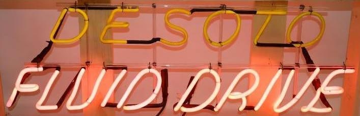 DeSoto Fluid Drive Neon Sign: This is a working neon sign that would have hung in the winow of a DeSoto dealership. It is currently mounted in a new wooden crate. The crate measures 46" x 22" x 13"". The neon sign measures 37" x 1