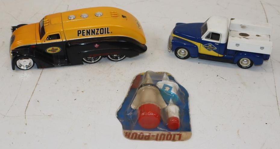 Group of 3 Toy Truck Banks and Liqui-Pour Toy Accessories: Largest is 9x3.5x3