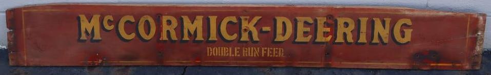 McCormick Deering Double Run Feed Wooden Tractor Sign: This is an early wooden sign that would've likely been on the side of a farm wagon. It has a great patina look with some light wear consistently throughout the field. 73" x 10". Graded 7.